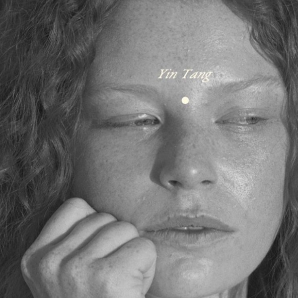 Woman with eyes closed, Yin Tang acupuncture point marked